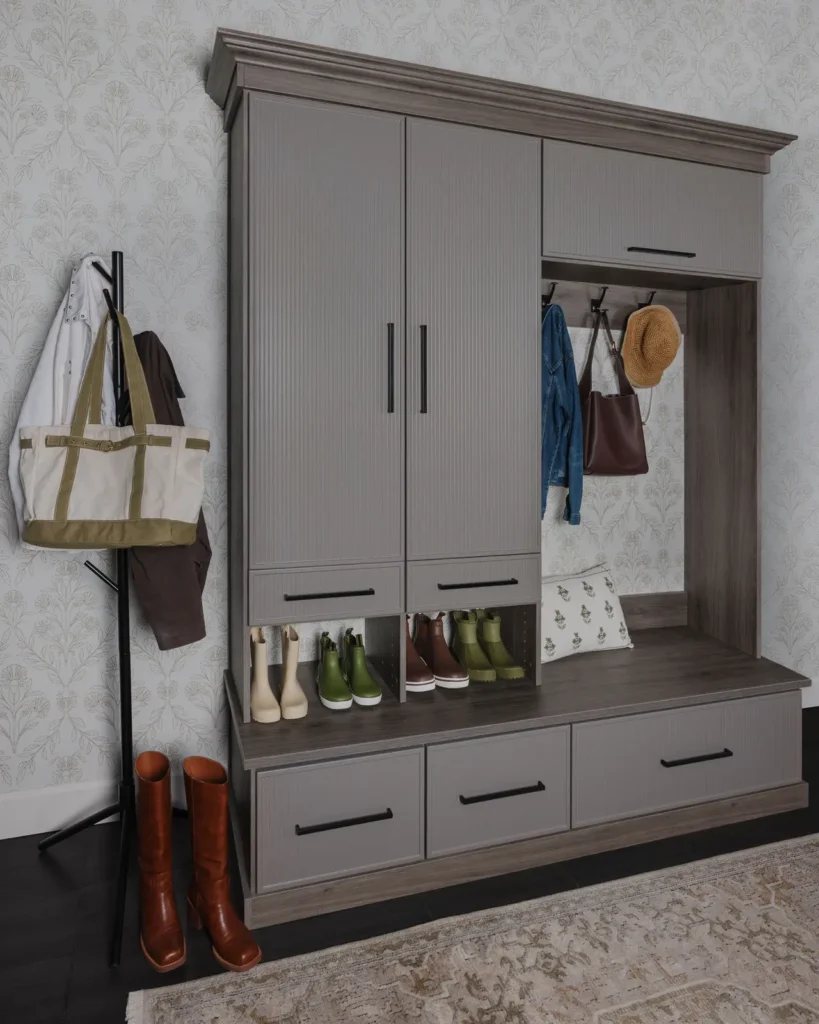 Custom mudroom bench with grey cabinets, coat hooks, shoe cubbies and drawers
