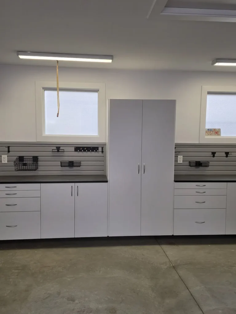 White garage cabinets with grey slatwall in the Edmonton area, after Famille Closets installation