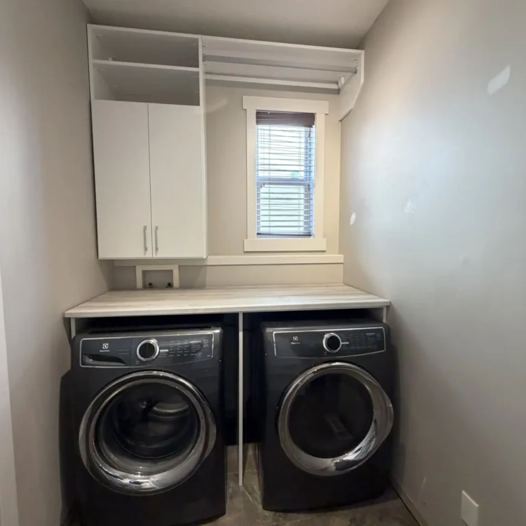 Laundry room with folding counter in Terwillegar, Edmonton, after Famille Closets installation