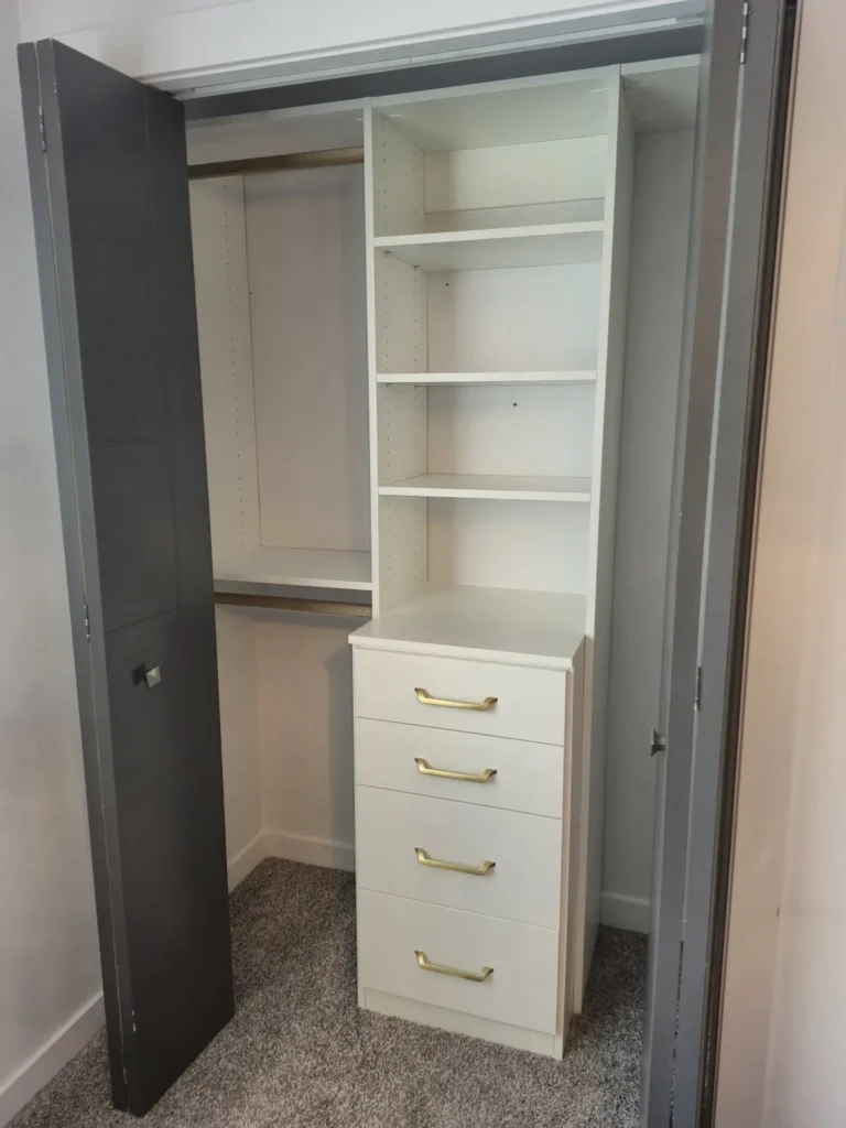 White reach-in closet with gold hardware in the Edmonton area, after Famille Closets installation