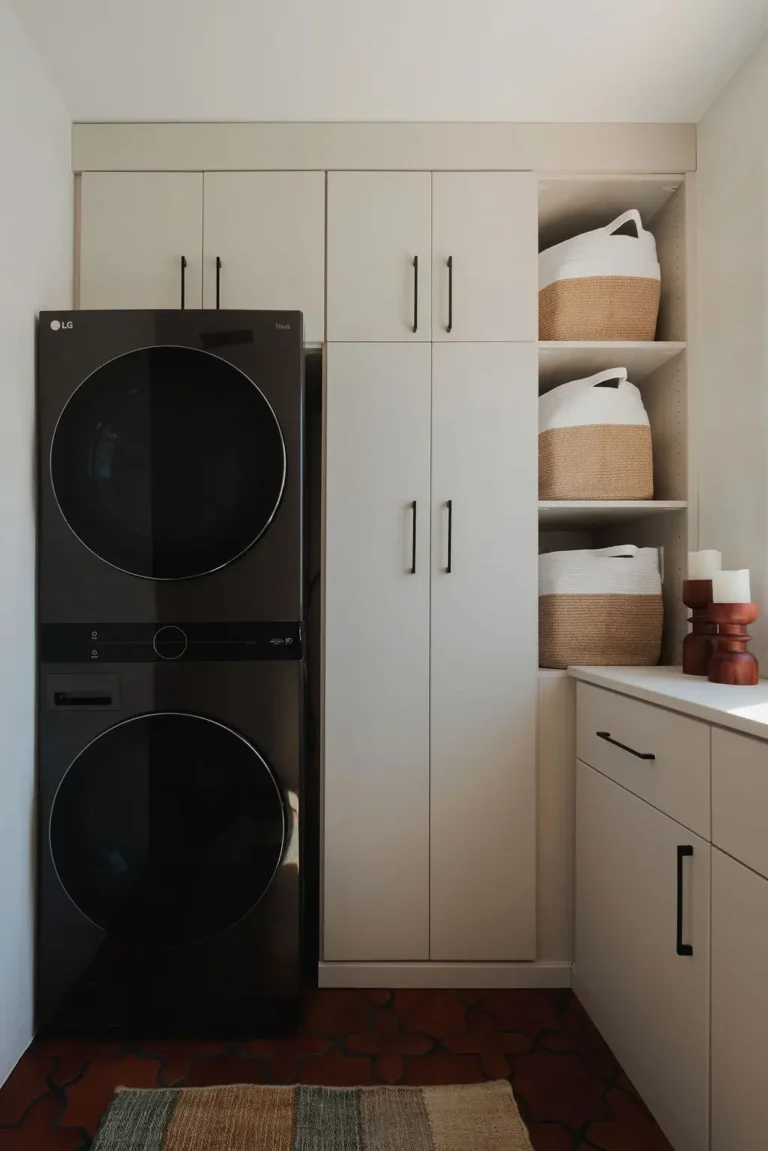 Vintage finish laundry room with tall cabinets, open shelving and a stacked washer and dryer