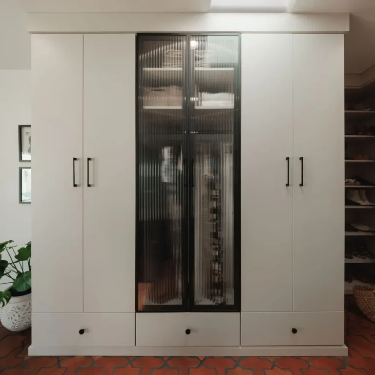 Vintage finish wardrobe wall with a fluted glass door and drawers