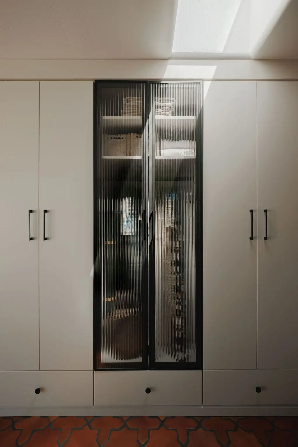 Vintage finish wardrobe with a fluted glass door between two cabinets