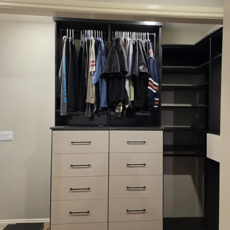 Black walk-in closet with pull-down rods in Spruce Grove, after Famille Closets installation