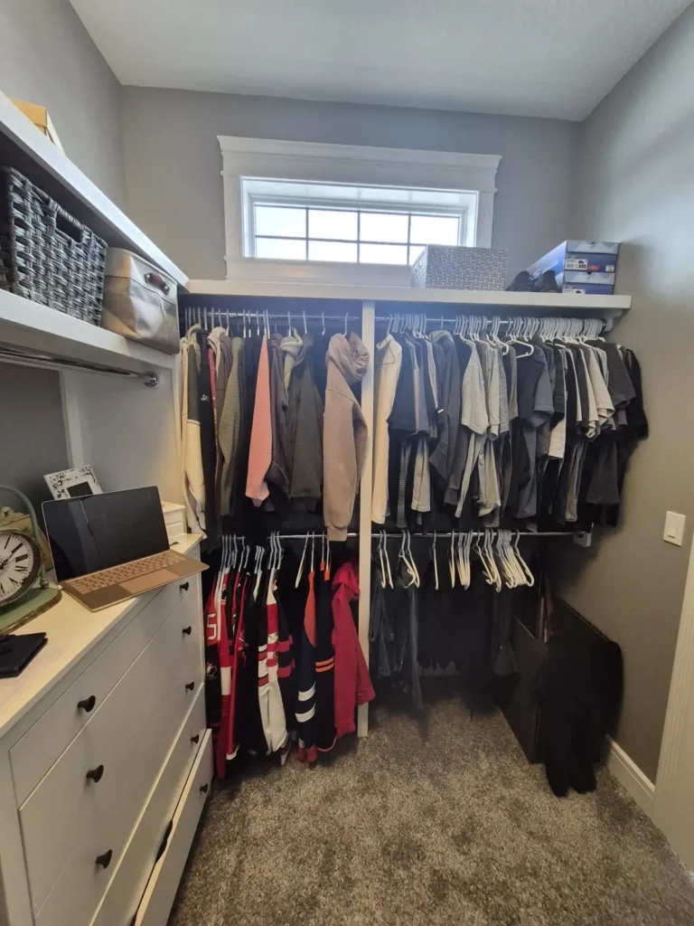 Walk-in closet in Spruce Grove before Famille Closets installation
