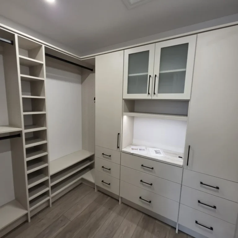 Vintage walk-in closet with glass-front cabinets in Sherwood Park, after Famille Closets installation
