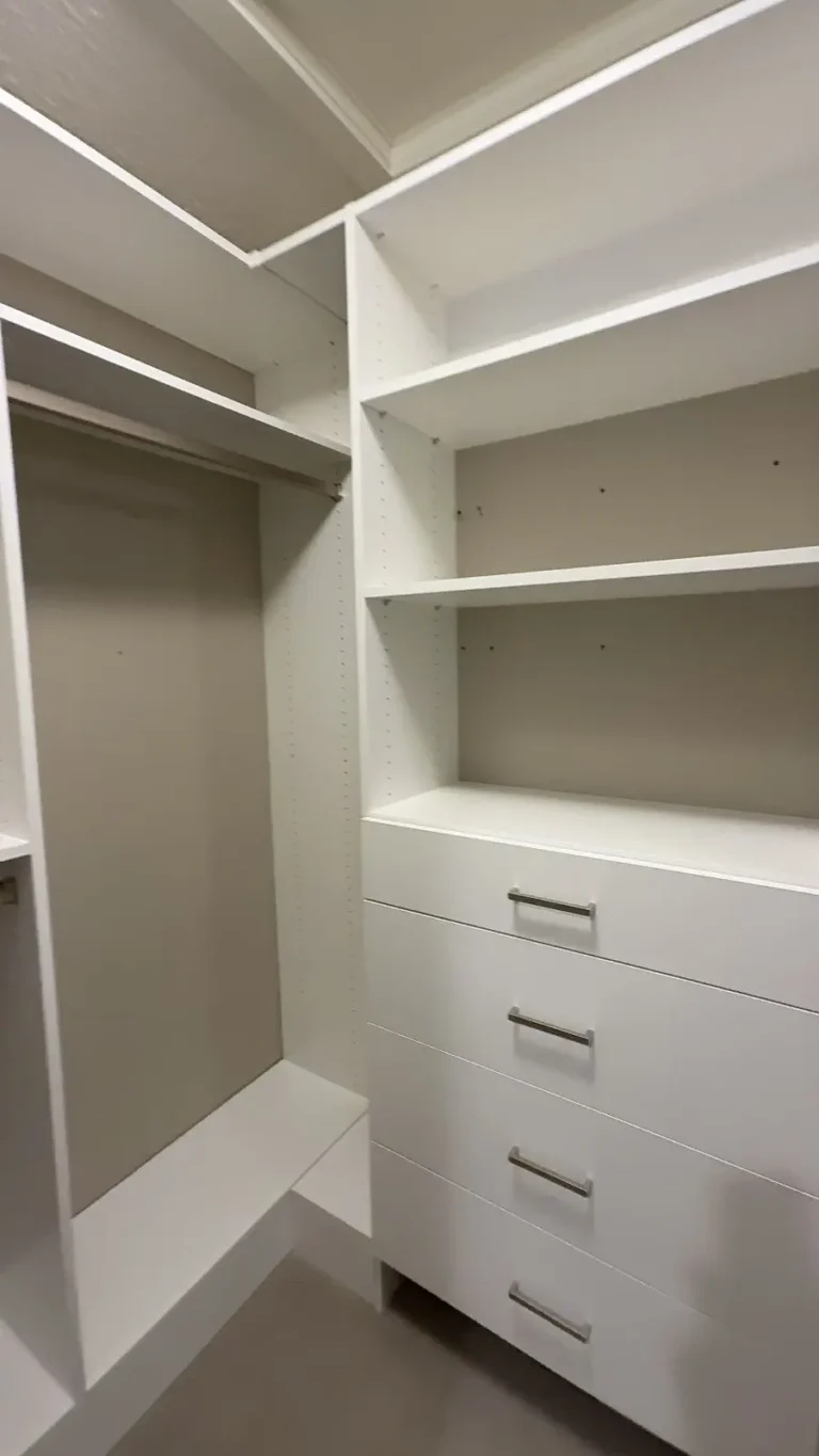 Long, narrow walk-in closet in Devon, after Famille Closets installation