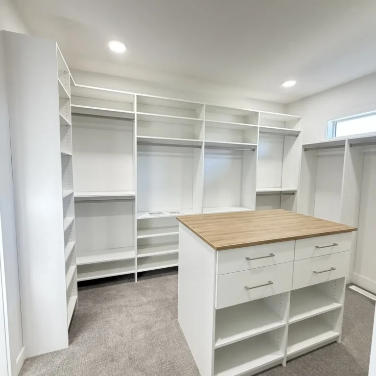 White walk-in closet with island in the Edmonton area, after Famille Closets installation