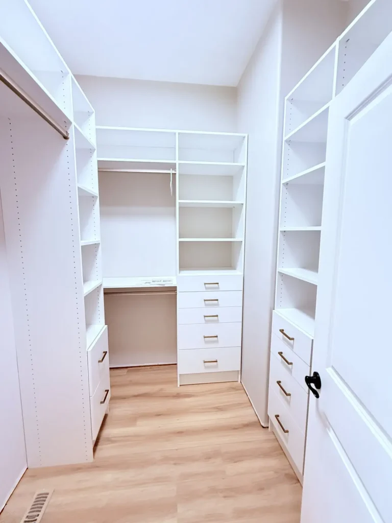 White walk-in closet with matte nickel hardware in Beaumont, after Famille Closets installation