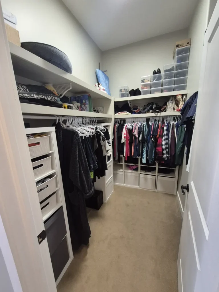Walk-in closet in Beaumont before Famille Closets installation