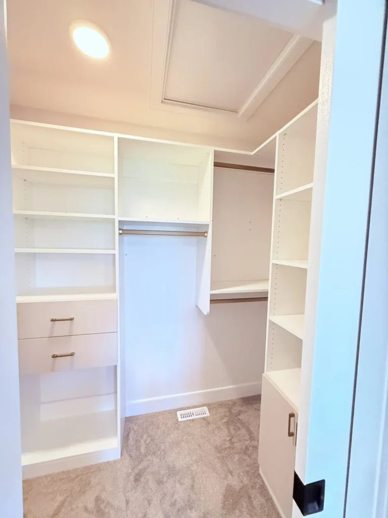 White walk-in closet in Southwest Edmonton, after Famille Closets installation