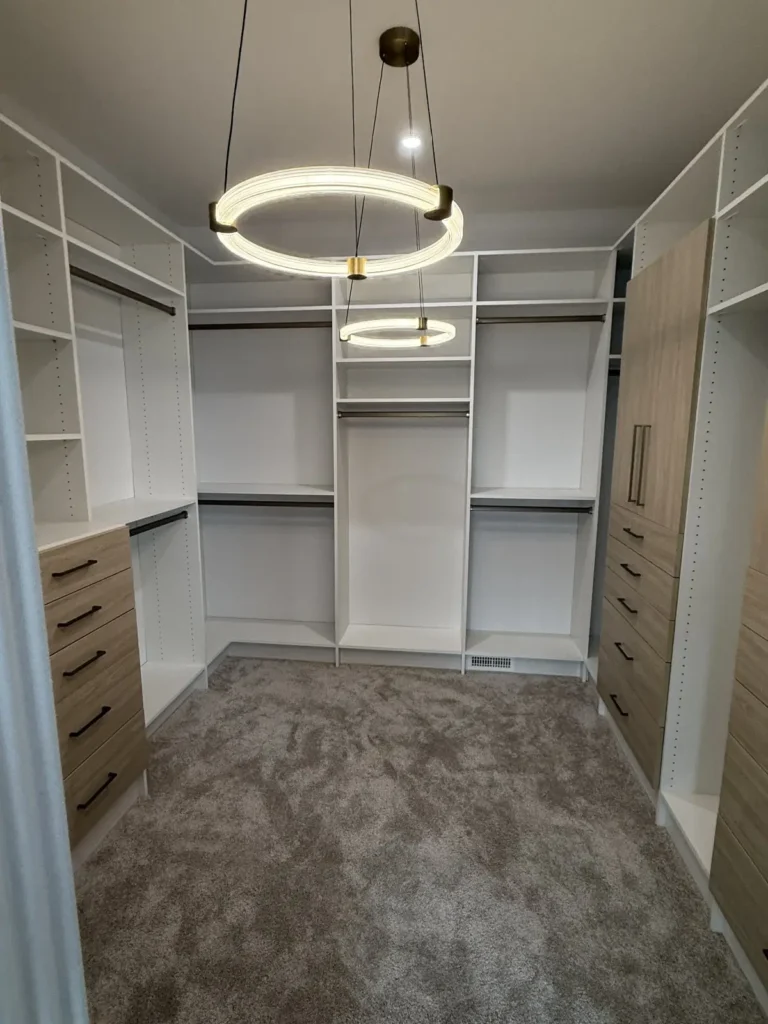White and woodgrain walk-in closet in the Edmonton area, after Famille Closets installation