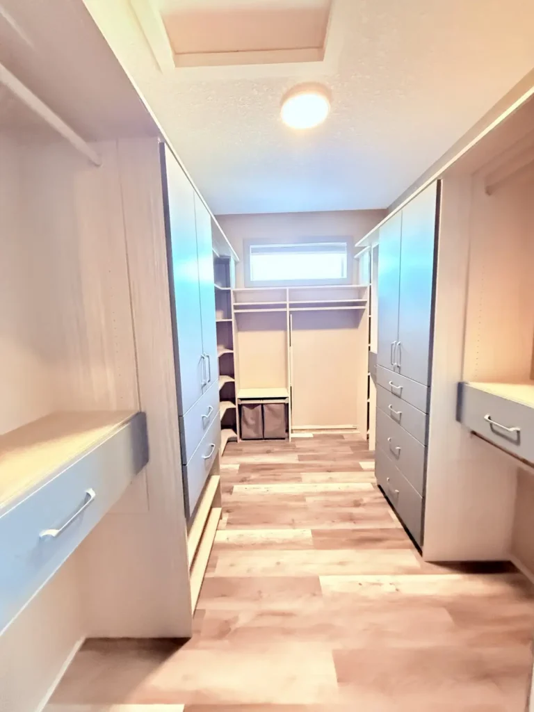 Woodgrain and slate-blue walk-in closet in Sherwood Park, after Famille Closets installation