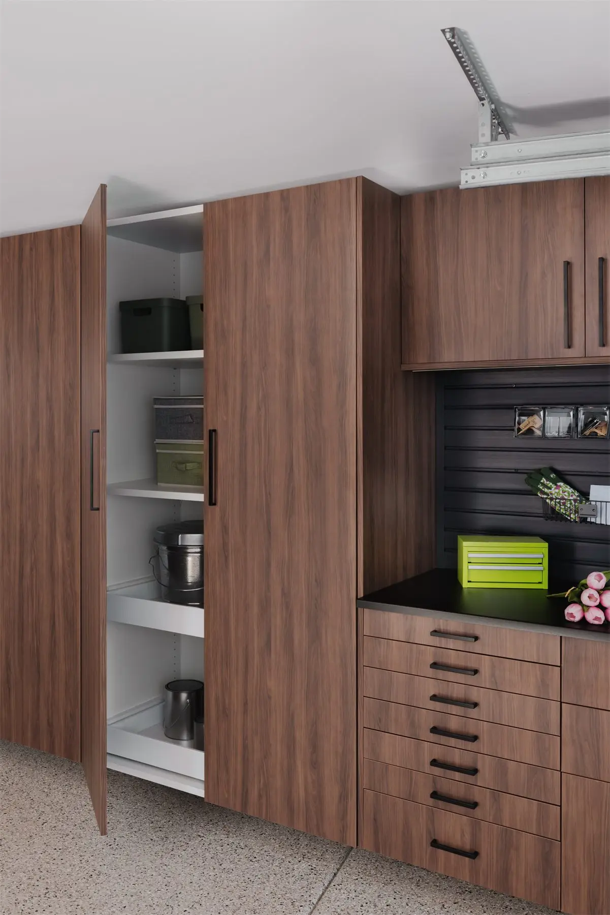Garage storage system with cabinet doors open by Famille Closets