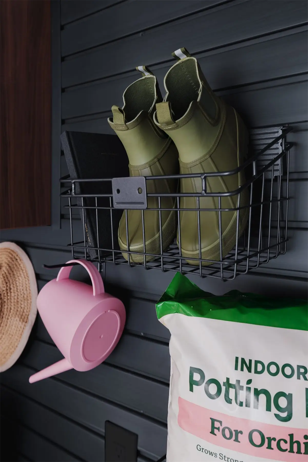 Slatwall basket for boots and gear by Famille Closets