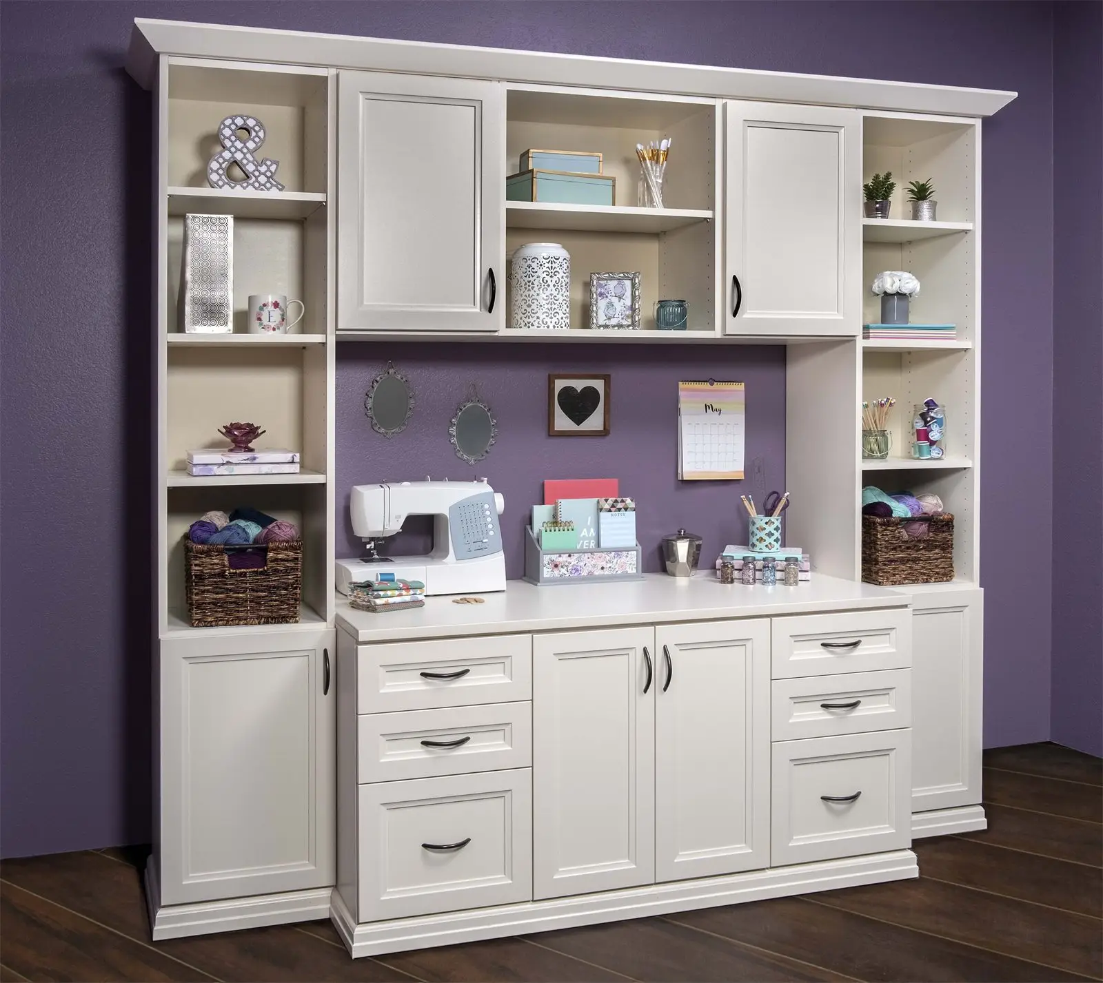 Antique white craft wall with a sewing counter, drawers and open shelving by Famille Closets