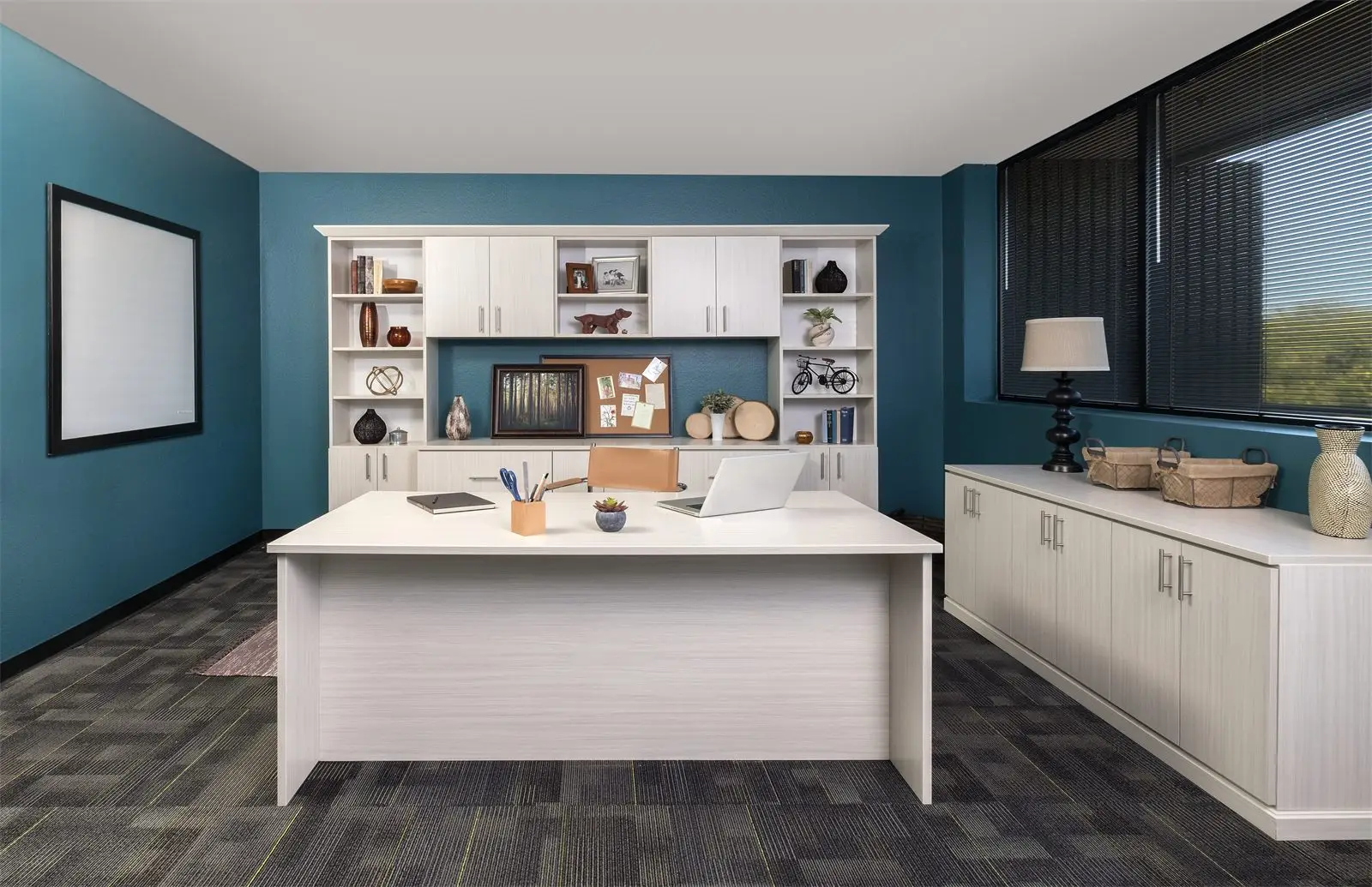 White flat-panel office with a desk facing a wall of shelving and cabinets by Famille Closets