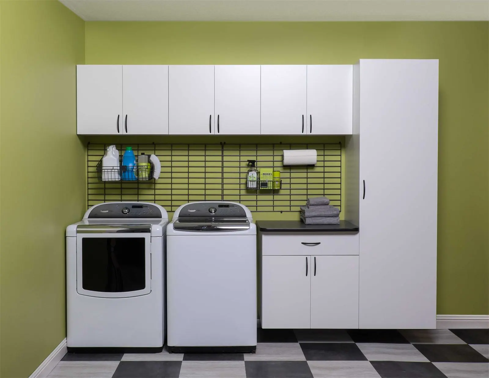 White laundry cabinets, wall organizer and tall cabinet seen straight on by Famille Closets
