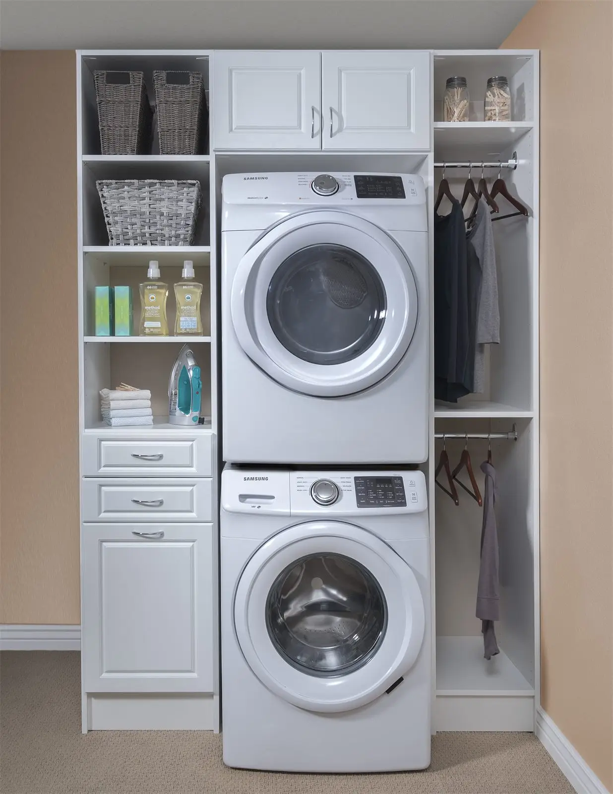 White raised-panel laundry wall with stacked washer and dryer, shelving and hanging space by Famille Closets