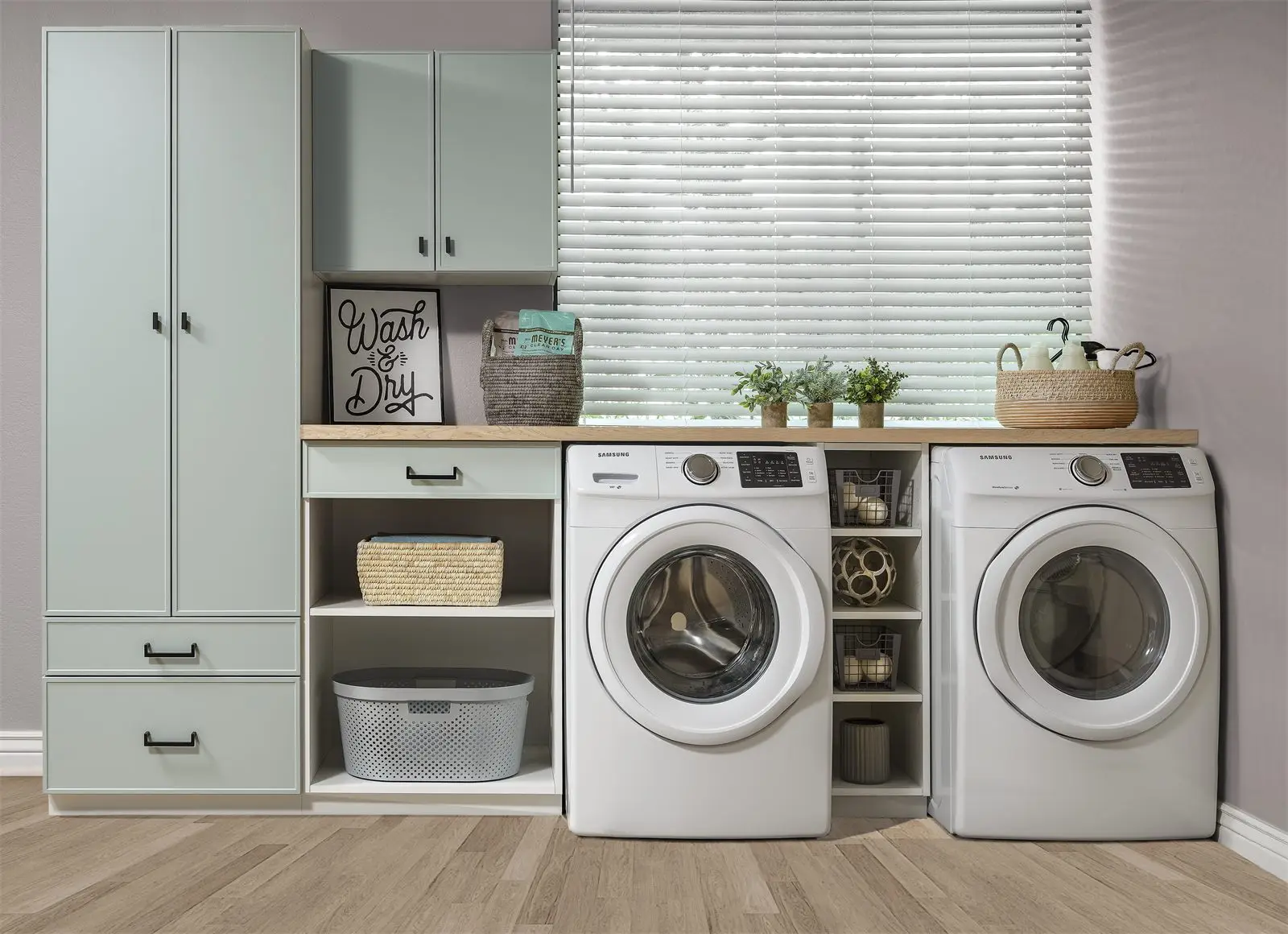 Dew green slim shaker laundry room with a counter over the machines and open cubbies by Famille Closets