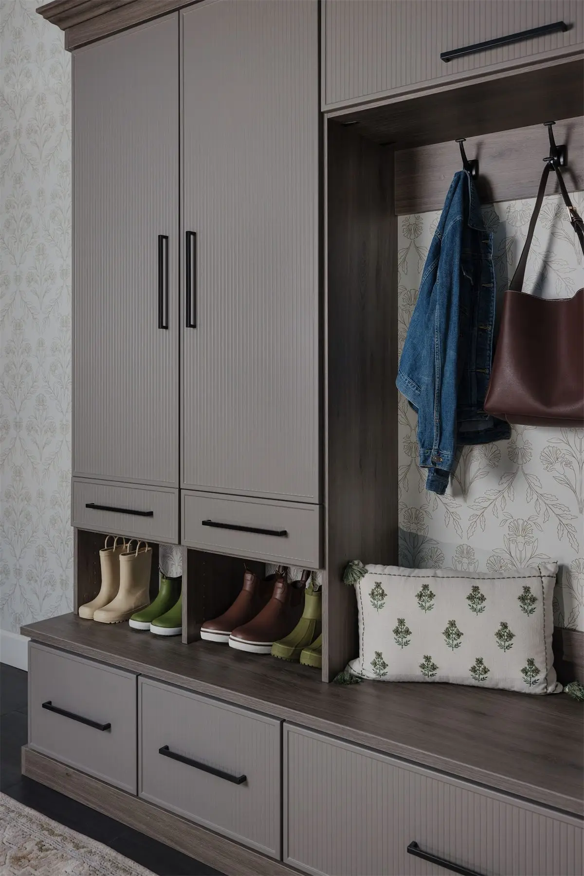 Mudroom built-in with tall cabinets and coat hooks by Famille Closets