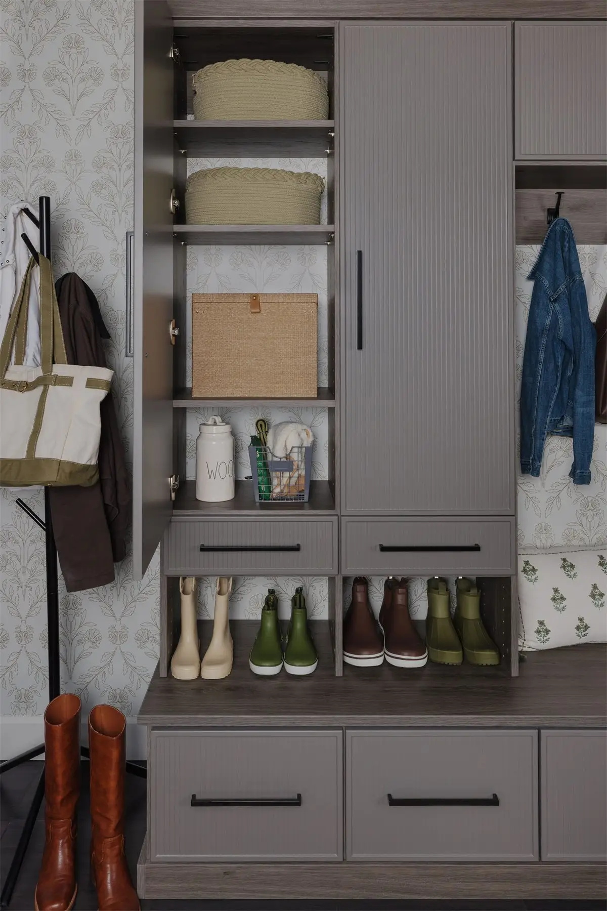 Mudroom with cabinet doors open by Famille Closets