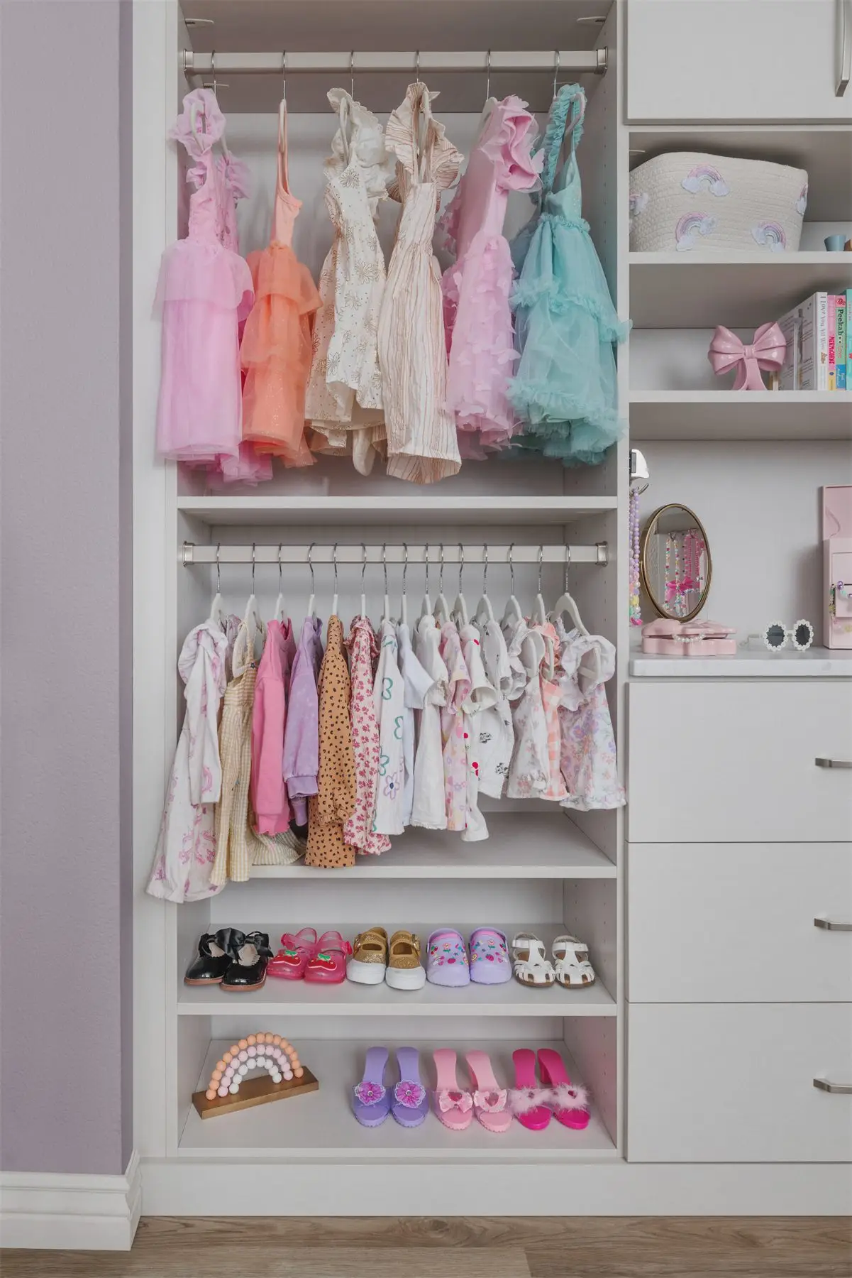 Linen kids closet with hanging rod and drawers by Famille Closets
