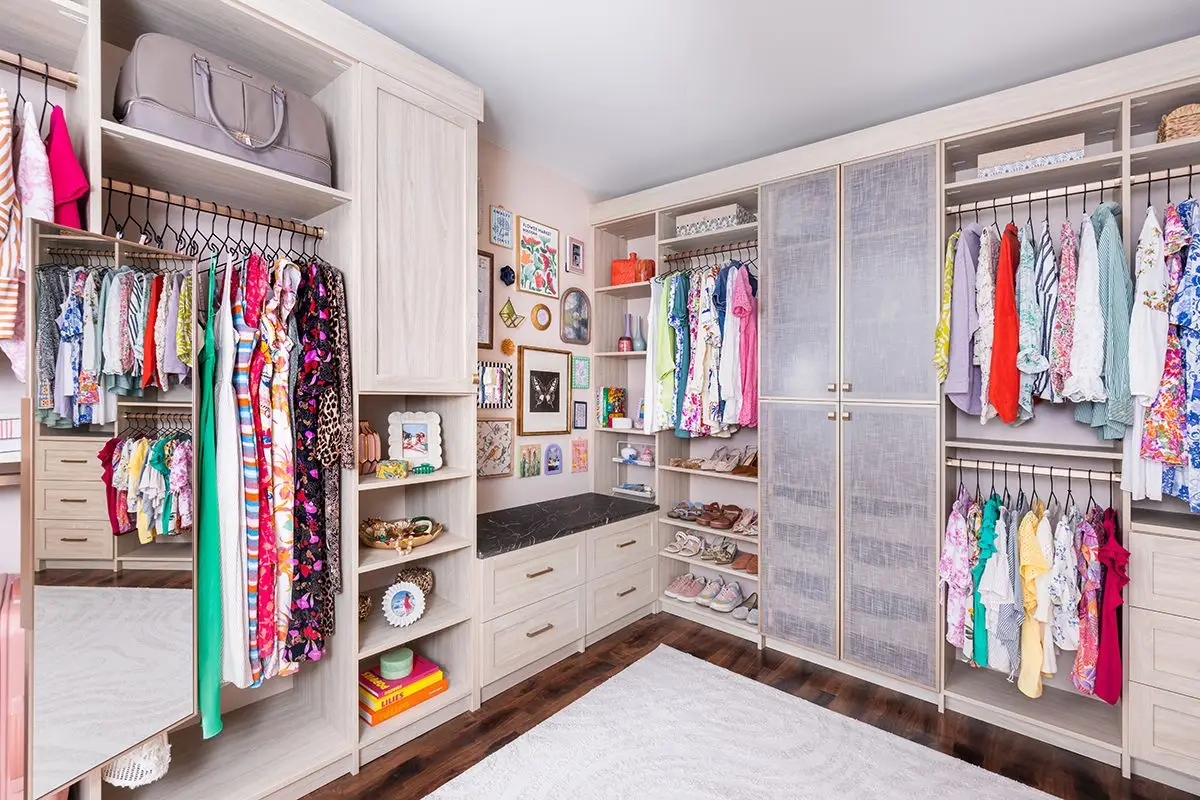 Dune shaker walk-in closet with shoe shelving and drawer bank by Famille Closets