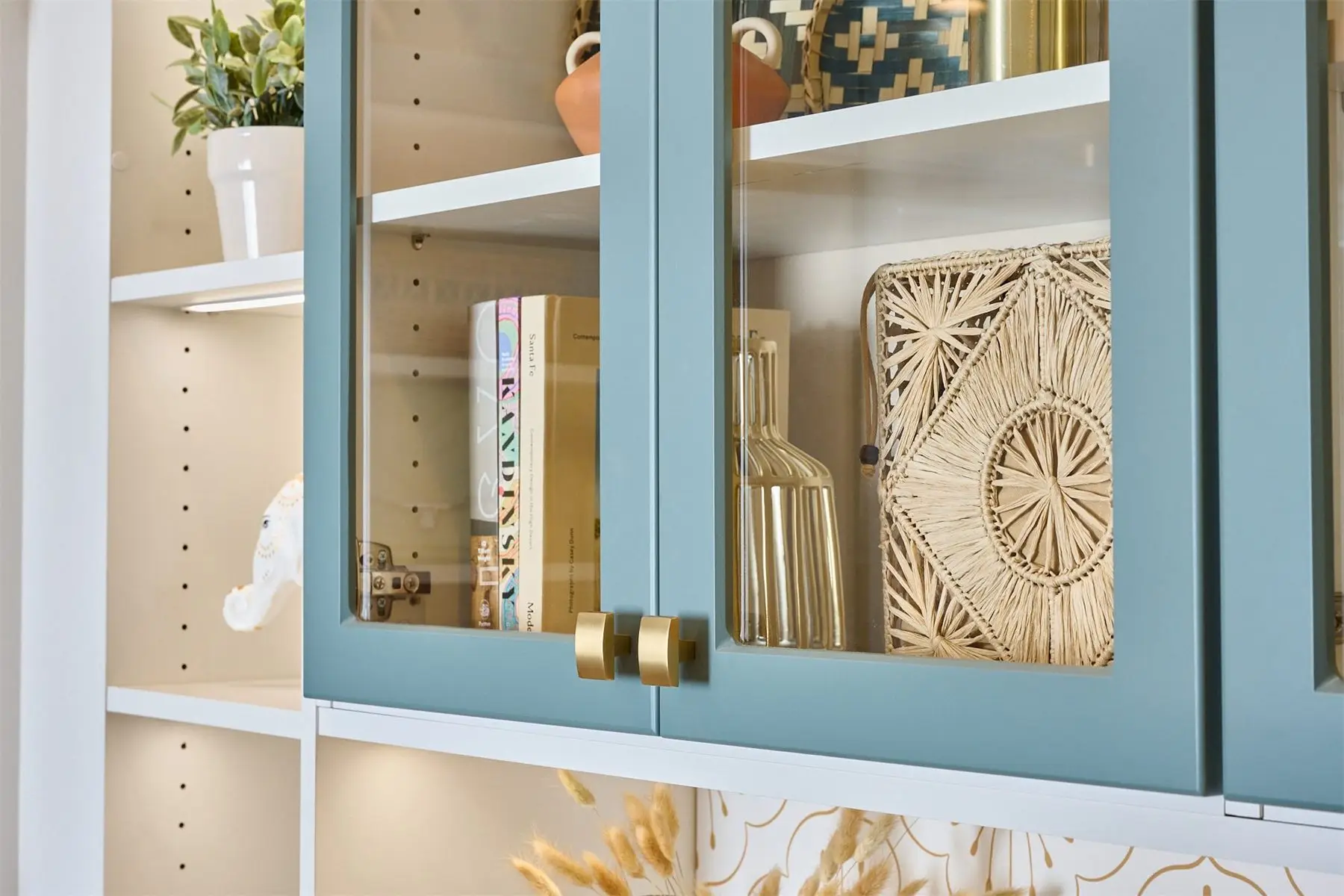 Glass-front closet doors with brass handles by Famille Closets