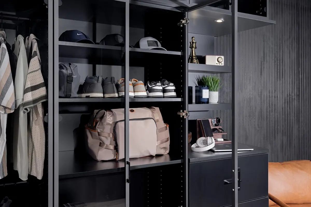 Black flat-panel closet with doors open by Famille Closets