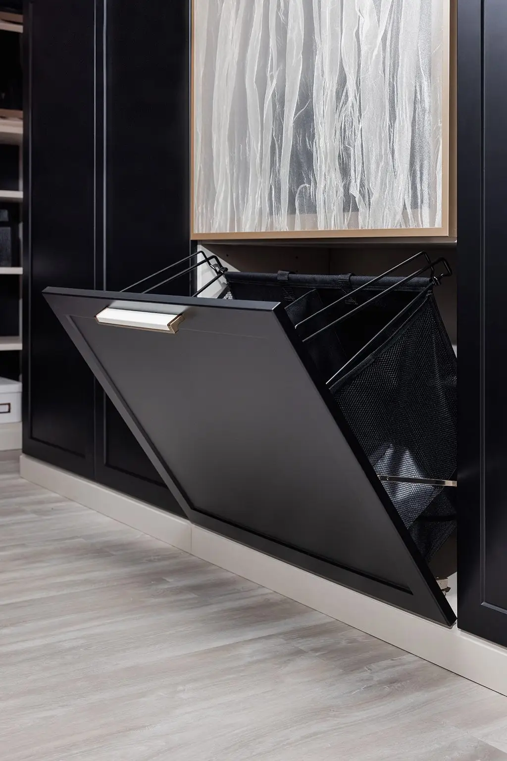 Built-in tilt-out hamper by Famille Closets